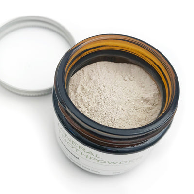 Close up of Akamai Mineral Toothpowder in a jar